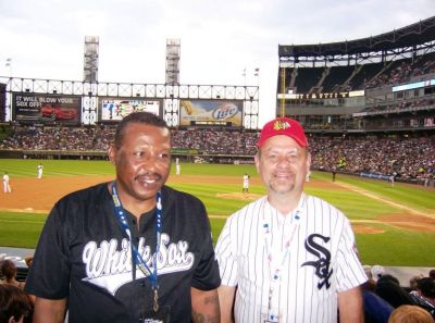 At White Sox game against Cleveland in Blackhawks cap with seats behind dugout
