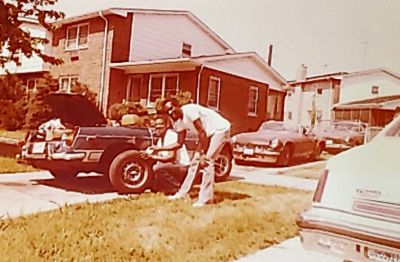 Calvin changing tire on Frank MGB
